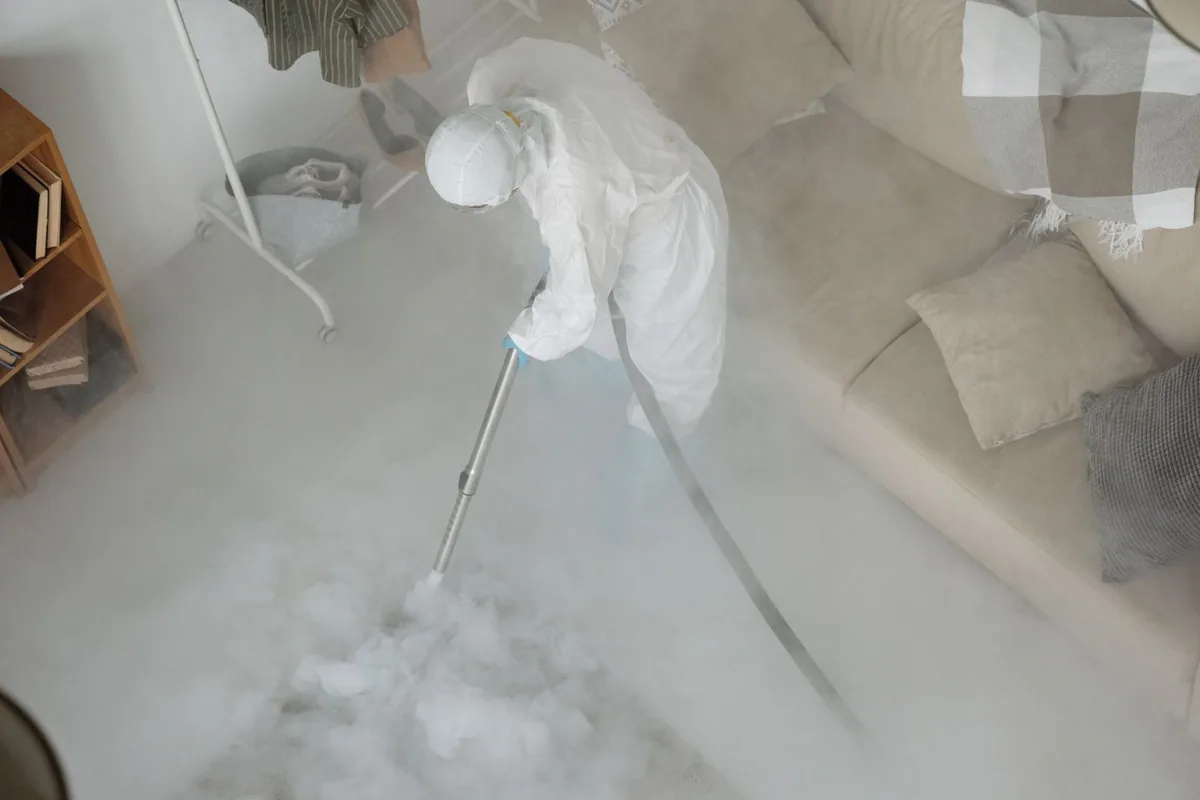 Biohazard cleanup technician in protective equipment, Lake Crystal, MN